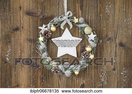 Christmas wreath on brown wooden wall with star View Large Photo Image Stock Photography - Christmas wreath on brown wooden wall with star. Fotosearch