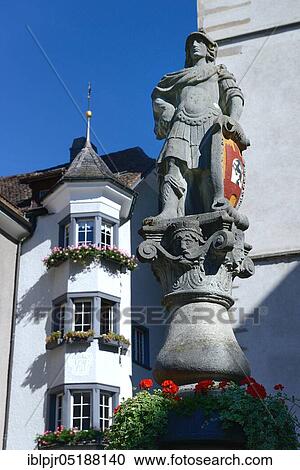 Stock Image - Chur, fountain figure, St. Martin's Fountain in front of St. Martin's Church, Old Town, Canton Graubünden, Switzerland, Europe. Fotosearch