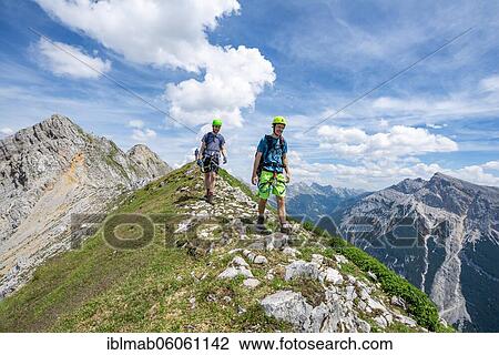 Climber on a ridge at a via ferrata, Mittenwalder Höhenweg, view on mountain panorama, Karwendel Mountains, Mittenwald, Bavaria, Germany, Europe View Large Photo Image Stock Image - Climber on a ridge at a via ferrata, Mittenwalder Höhenweg, view on mountain panorama, Karwendel Mountains, Mittenwald, Bavaria, Germany, Europe. Fotosearch