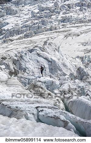 Climber standing on rifted glacier, glacier ice with crevasses, glacier tongue, Glacier des Bossons, La Jonction, Chamonix, Haute-Savoie, France, Europe View Large Photo Image Picture - Climber standing on rifted glacier, glacier ice with crevasses, glacier tongue, Glacier des Bossons, La Jonction, Chamonix, Haute-Savoie, France, Europe. Fotosearch