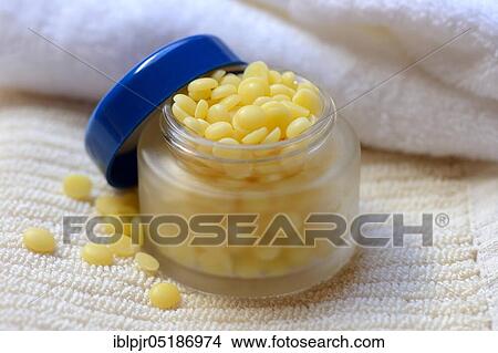 Picture - Cocoa butter in glass jar( Theobroma cacao), cocoa fat, oleum cacao. Fotosearch