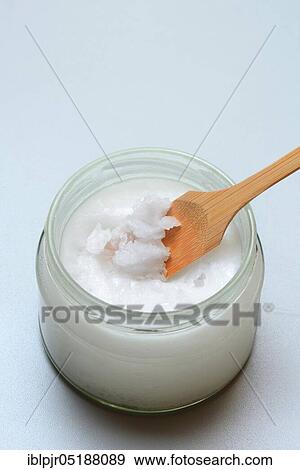 Stock Photo - Coconut oil with bamboo spatula. Fotosearch