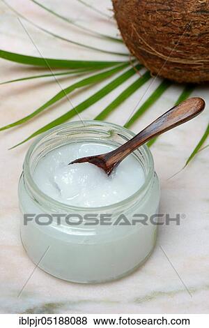 Coconut oil with wooden spoon View Large Photo Image Stock Photo - Coconut oil with wooden spoon. Fotosearch
