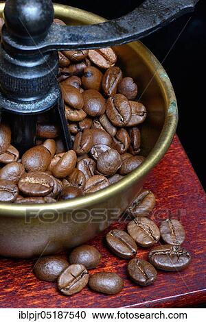 Stock Image - Coffee beans in a coffee mill. Fotosearch