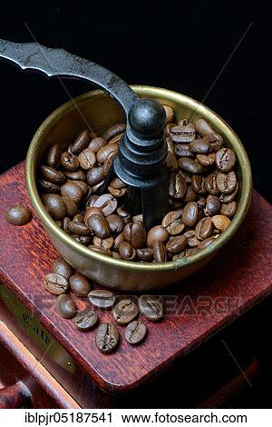 Stock Image - Coffee beans in a coffee mill. Fotosearch
