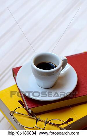 Picture - Coffee cup on books and glasses, espresso. Fotosearch