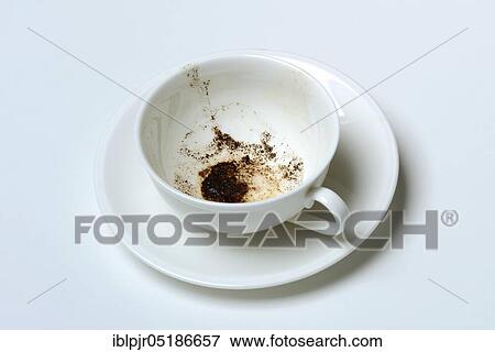 Stock Photo - Coffee grounds in cup, read coffee grounds. Fotosearch