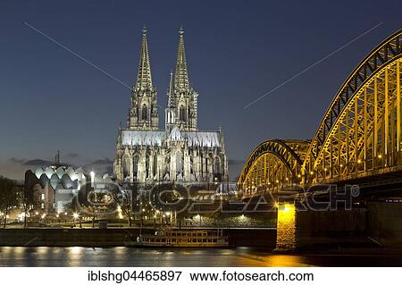 Stock Photo - Cologne Cathedral and Philharmonic Hall with Hohenzollern Bridge, night scene, Cologne, Köln, North Rhine-Westphalia, Germany, Europe. Fotosearch