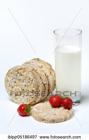 Stock Photo - Corn and rice waffles with glass of milk and strawberries. Fotosearch
