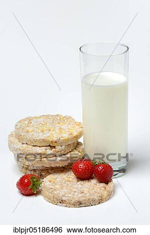 Stock Photograph - Corn and rice waffles with glass of milk and strawberries. Fotosearch