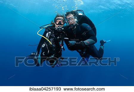 Couple, divers in the water holding hands, Indian Ocean, Maldives, Asia View Large Photo Image Stock Image - Couple, divers in the water holding hands, Indian Ocean, Maldives, Asia. Fotosearch