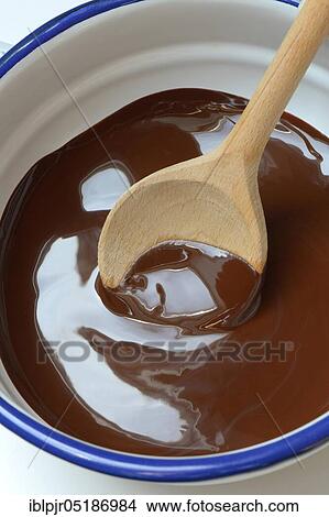 Couverture, melted block chocolate with cooking spoon View Large Photo Image Picture - Couverture, melted block chocolate with cooking spoon. Fotosearch