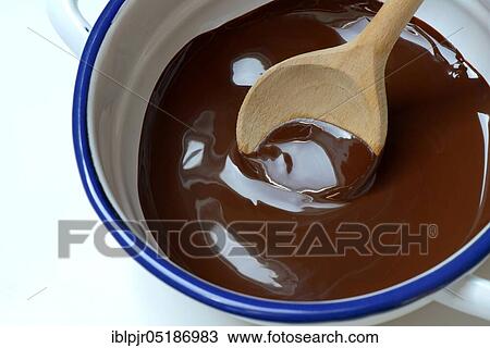 Stock Image - Couverture, melted block chocolate with cooking spoon. Fotosearch