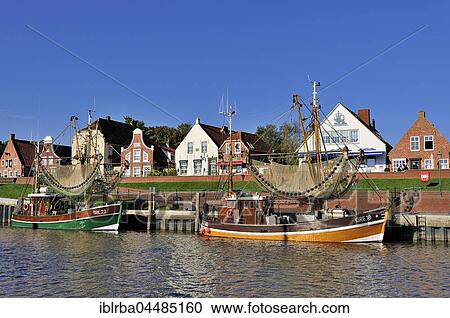 Crab cutters in the harbor, in front of historical buildings, Greetsiel, Lower Saxony, Germany, Europe View Large Photo Image Stock Image - Crab cutters in the harbor, in front of historical buildings, Greetsiel, Lower Saxony, Germany, Europe. Fotosearch