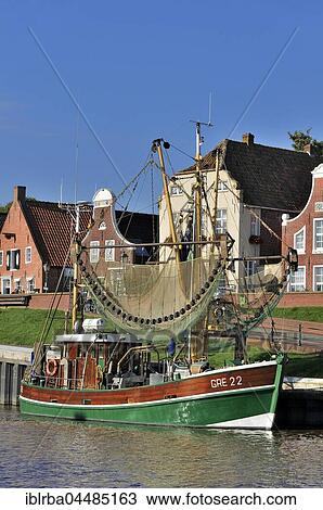 Crab cutters in the harbor, in front of historical buildings, Greetsiel, Lower Saxony, Germany, Europe View Large Photo Image Stock Image - Crab cutters in the harbor, in front of historical buildings, Greetsiel, Lower Saxony, Germany, Europe. Fotosearch