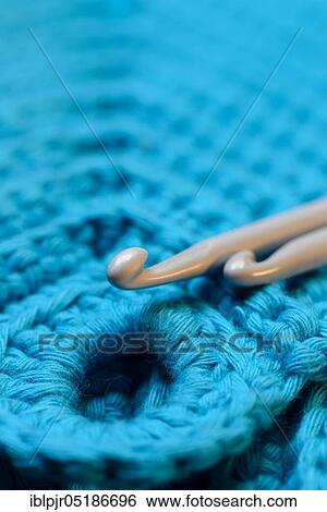Stock Photograph - Crochet hook, crochet hooks with crochet work, crochet, handmade, handmade, handmade, crochet work, crochet, creative, wool, yarn, crochet wool, crochet yarn, handmade, portrait. Fotosearch