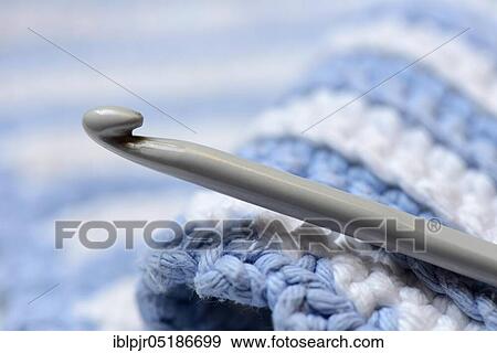 Stock Photo - Crochet hooks with manual work. Fotosearch