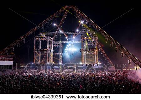 Stock Image - Crowd at Laser Show, Festival Techno Rave Nature One 2016, Red Dancing Flames, Hunsrück, Kastellaun, Rhineland-Palatinate, Germany, Europe. Fotosearch