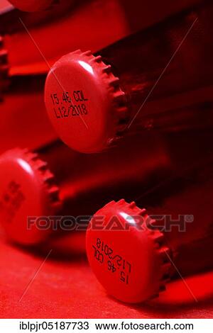 Stock Image - Crown cap with coding on bottles, coding, Campari. Fotosearch