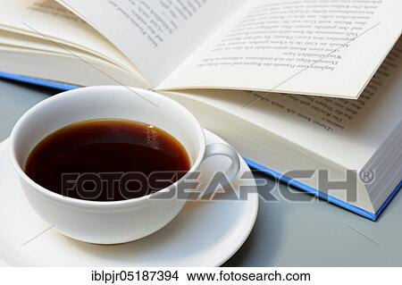 Cup of coffee and book View Large Photo Image Picture - Cup of coffee and book. Fotosearch