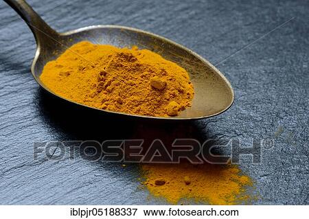Stock Photo - Curcuma powder in spoon, turmeric longa. Fotosearch