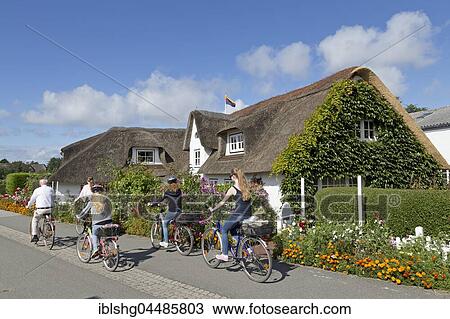 Cyclists in front of thatched house, Nebel, Amrum, North Frisia, Schleswig-Holstein, Germany, Europe View Large Photo Image Stock Image - Cyclists in front of thatched house, Nebel, Amrum, North Frisia, Schleswig-Holstein, Germany, Europe. Fotosearch