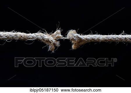 Stock Image - Defective jute rope, on a silk thread, torn, frayed. Fotosearch