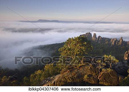 Dense fog, morning atmosphere, view from the Schrammstein prospect Elbe Valley in the Saxon Switzerland, Saxon Switzerland, Saxony, Germany, Europe View Large Photo Image Stock Photograph - Dense fog, morning atmosphere, view from the Schrammstein prospect Elbe Valley in the Saxon Switzerland, Saxon Switzerland, Saxony, Germany, Europe. Fotosearch