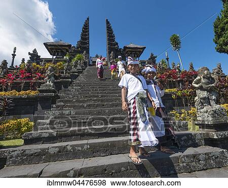 Stock Photo - Devout Balinese descend stairs, split gate, Candi bentar, mother temple Besakih, Pura Agung Besakih Penetaran, Banjar Besakih, Bali, Indonesia, Asia. Fotosearch