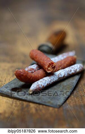 Stock Photograph - Different kinds of sausages on a chopper. Fotosearch