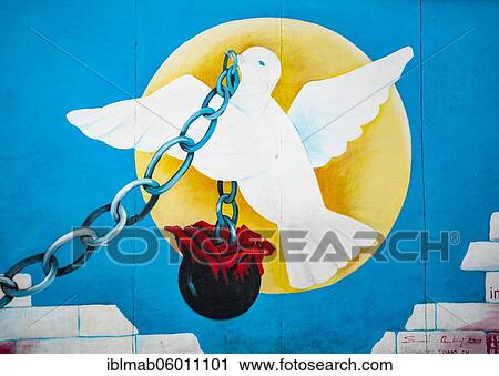 Dove of peace in front of sun carries chain with weight, artist Andrej Smolák, mural at the East Side Gallery, Berlin Wall, Berlin, Germany, Europe View Large Photo Image Stock Image - Dove of peace in front of sun carries chain with weight, artist Andrej Smolák, mural at the East Side Gallery, Berlin Wall, Berlin, Germany, Europe. Fotosearch