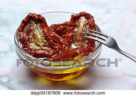 Dried tomatoes in olive oil, Solanum lycopersicum View Large Photo Image Stock Photograph - Dried tomatoes in olive oil, Solanum lycopersicum. Fotosearch