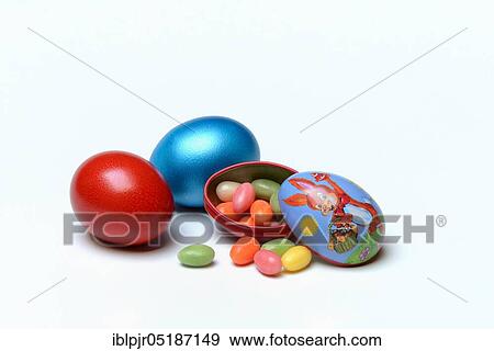 Easter eggs and sugar eggs in tin egg with rabbit figure View Large Photo Image Stock Photo - Easter eggs and sugar eggs in tin egg with rabbit figure. Fotosearch