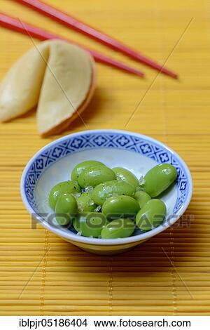 Edamame, cooked unripe Soya beans (Glycine max) in bowl, seasoned salt Shichimi Togarashi View Large Photo Image Picture - Edamame, cooked unripe Soya beans (Glycine max) in bowl, seasoned salt Shichimi Togarashi. Fotosearch