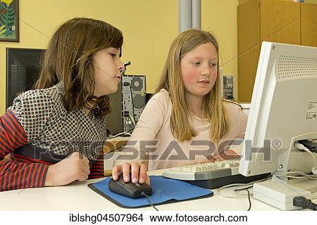 Elementary school girls working in computer room, Lower Saxony, Germany, Europe View Large Photo Image Picture - Elementary school girls working in computer room, Lower Saxony, Germany, Europe. Fotosearch