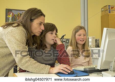 Elementary school girls working in computer room, Lower Saxony, Germany, Europe View Large Photo Image Stock Image - Elementary school girls working in computer room, Lower Saxony, Germany, Europe. Fotosearch