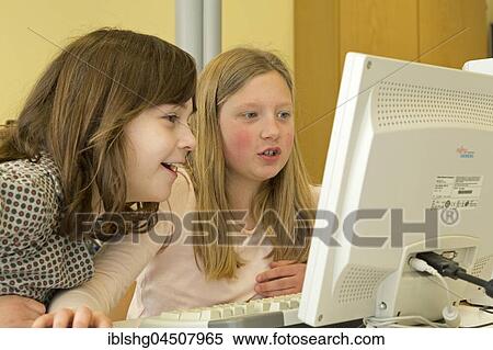 Elementary school girls working in computer room, Lower Saxony, Germany, Europe View Large Photo Image Stock Photography - Elementary school girls working in computer room, Lower Saxony, Germany, Europe. Fotosearch