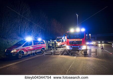 Emergency vehicles in an accident on the highway at night, ambulance and fire brigade, Köngen, Baden-Württemberg, Germany, Europe View Large Photo Image Picture - Emergency vehicles in an accident on the highway at night, ambulance and fire brigade, Köngen, Baden-Württemberg, Germany, Europe. Fotosearch