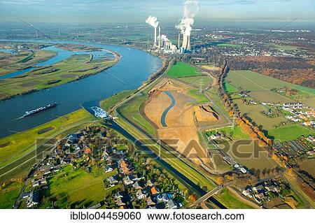 Stock Image - Emscher flowing into the Rhine, Rheinaue wetlands, power plant Voerde at back, Dinslaken, Ruhr district, North Rhine-Westphalia, Germany, Europe. Fotosearch