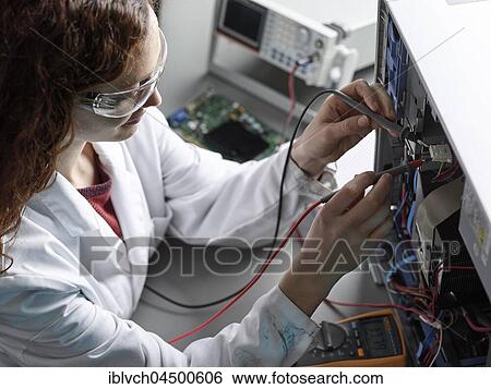 Engineer with white lab coat and goggles measures current with a meter, Austria, Europe View Large Photo Image Stock Photograph - Engineer with white lab coat and goggles measures current with a meter, Austria, Europe. Fotosearch