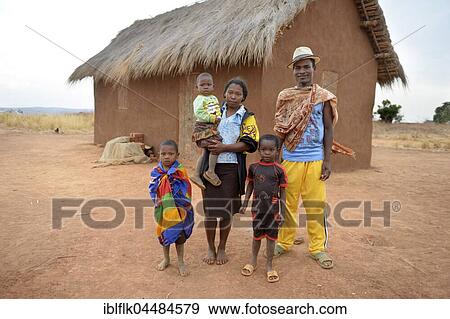 Family with three children in front of hut, Tsiroanomandidy district, Bongolava region, Madagascar, Africa View Large Photo Image Stock Photo - Family with three children in front of hut, Tsiroanomandidy district, Bongolava region, Madagascar, Africa. Fotosearch