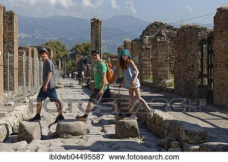 Father and children walking on historical stones, Via Stabiana, ancient city, Pompeii, Campania, Italy, Europe View Large Photo Image Stock Photo - Father and children walking on historical stones, Via Stabiana, ancient city, Pompeii, Campania, Italy, Europe. Fotosearch