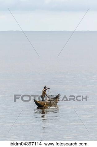Fisherman in a pirogue, logboat, throwing out a net, Kribi, Southern Region, Cameroon, Africa View Large Photo Image Picture - Fisherman in a pirogue, logboat, throwing out a net, Kribi, Southern Region, Cameroon, Africa. Fotosearch