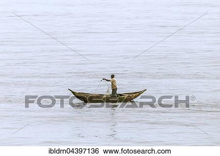 Fisherman in a pirogue, logboat, throwing out a net, Kribi, Southern Region, Cameroon, Africa View Large Photo Image Stock Photograph - Fisherman in a pirogue, logboat, throwing out a net, Kribi, Southern Region, Cameroon, Africa. Fotosearch