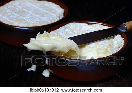Stock Image - French soft cheese in clay pot, Saint-Marcellin, France, Europe. Fotosearch