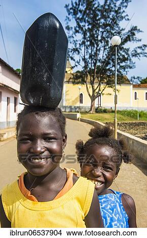 Friendly girls carrying a water canister, east coast of Sao Tome, Sao Tome and Principe, Atlantic Ocean, Africa View Large Photo Image Picture - Friendly girls carrying a water canister, east coast of Sao Tome, Sao Tome and Principe, Atlantic Ocean, Africa. Fotosearch