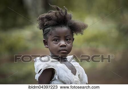 Girl with unique hairstyle, street scene, Fundong, North-West Region, Cameroon, Africa View Large Photo Image Stock Image - Girl with unique hairstyle, street scene, Fundong, North-West Region, Cameroon, Africa. Fotosearch
