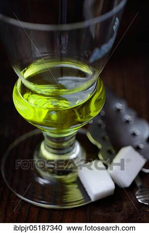 Glass of absinthe with absinthe spoon and sugar cubes, Green Fairy View Large Photo Image Stock Image - Glass of absinthe with absinthe spoon and sugar cubes, Green Fairy. Fotosearch
