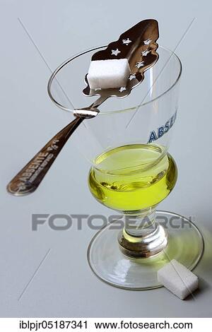 Glass of absinthe with absinthe spoon and sugar cubes, Green Fairy View Large Photo Image Stock Image - Glass of absinthe with absinthe spoon and sugar cubes, Green Fairy. Fotosearch