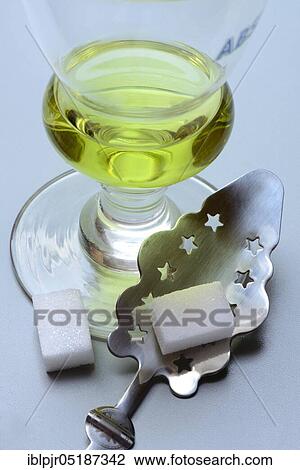 Glass of absinthe with absinthe spoon and sugar cubes, Green Fairy View Large Photo Image Stock Image - Glass of absinthe with absinthe spoon and sugar cubes, Green Fairy. Fotosearch